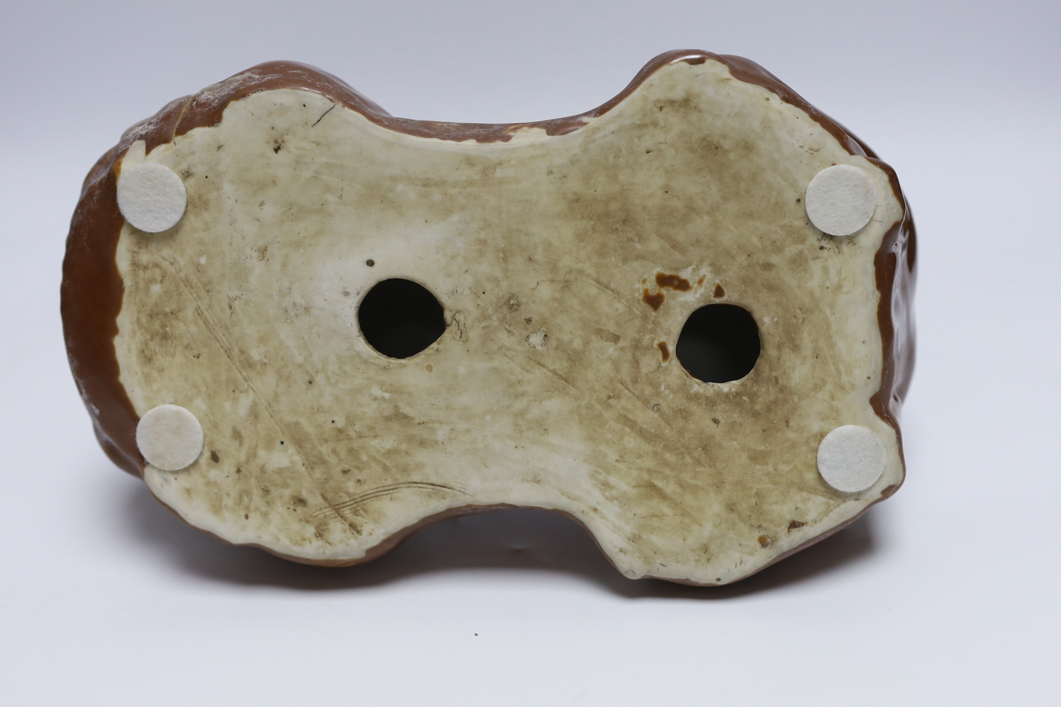 A Chinese porcelain ‘boy’ headrest, 29cm long